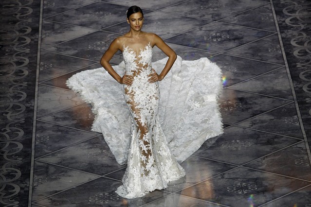 Russian model Irina Shayk presents a creation of the Atelier Pronovias 2016 collection during the Barcelona Bridal Week at the Museu Nacional d’Art de Catalunya (MNAC) in Barcelona, on May 8 , 2015.   AFP PHOTO/ QUIQUE GARCIA