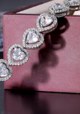 Detalle de pulsera de oro blanco y diamantes en forma de corazón