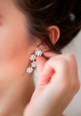 Detalle de pendientes de oro blanco y diamantes en modelo
